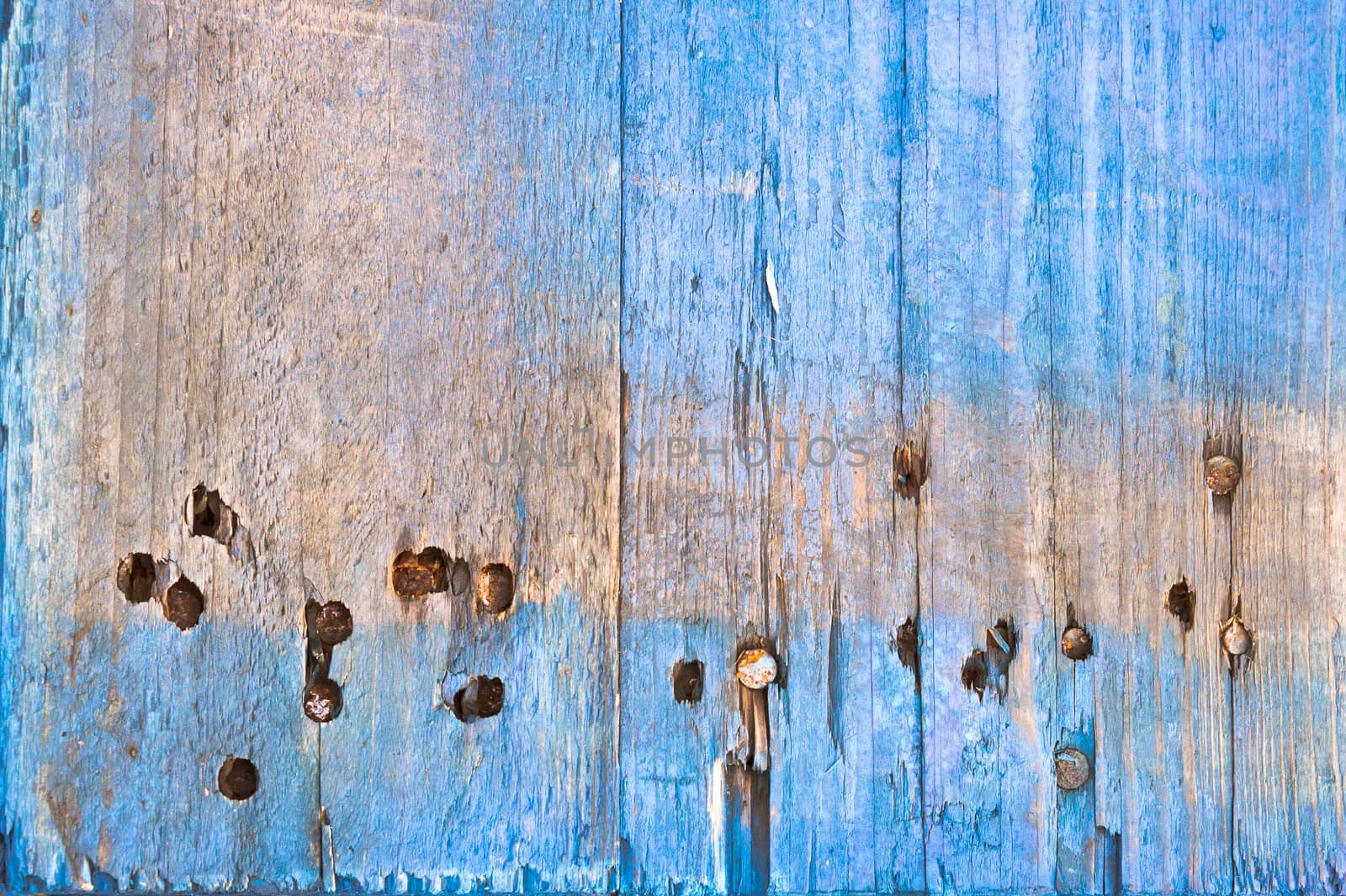 Weathered blue wood with rusty nails as a background