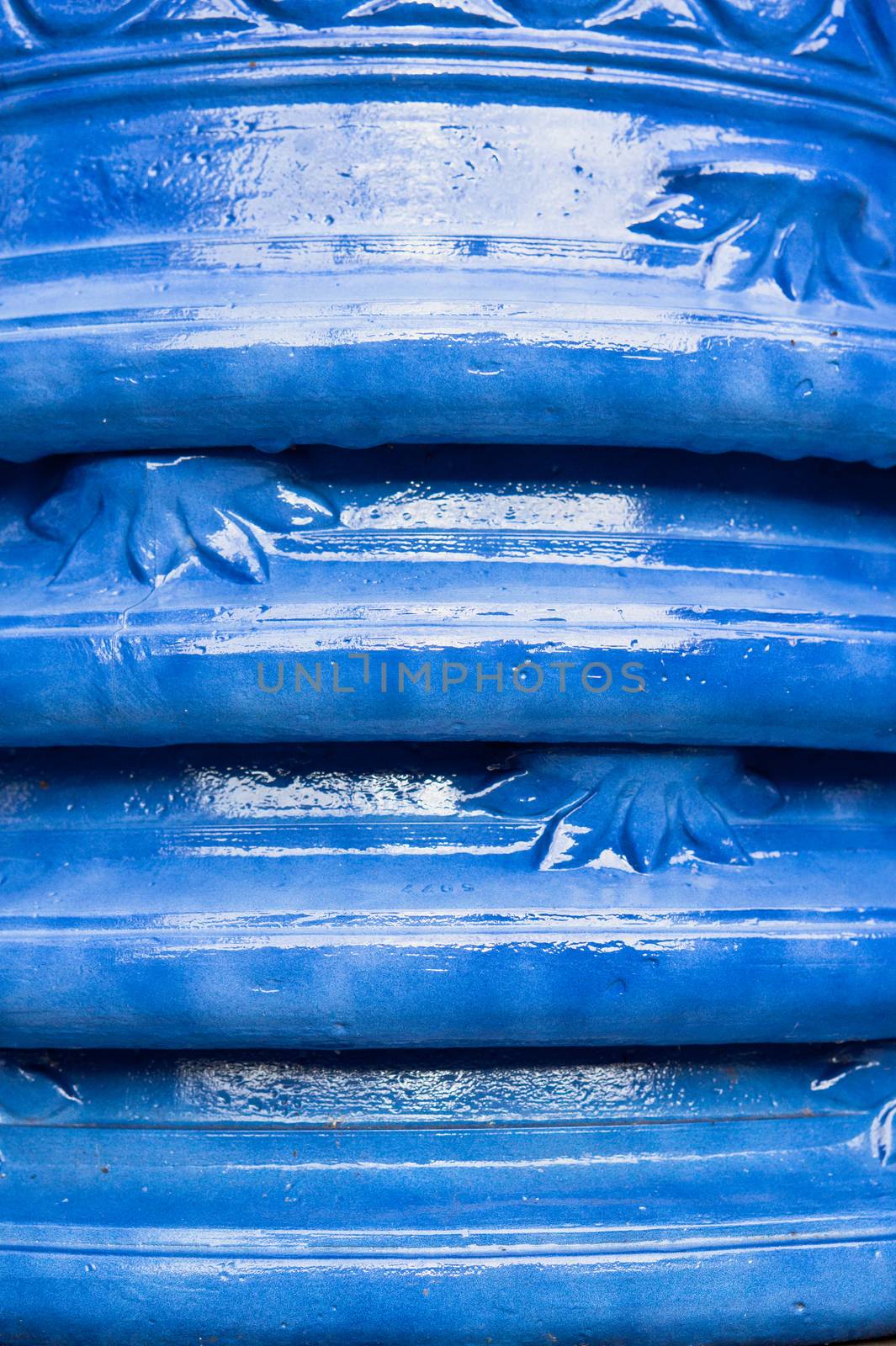 Close up of the rims of a stack of blue clay pots