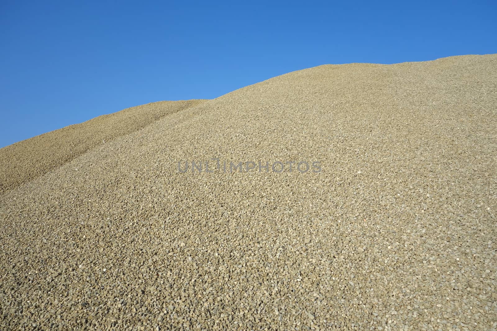 Pile of green gravel - sand, ready to be used as a construction material