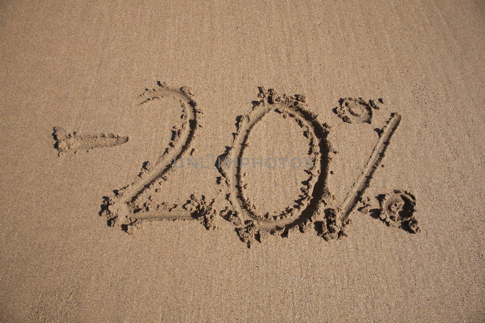 20 per cent discount in earth text written on brown sand ground low tide beach ocean seashore in Spain Europe