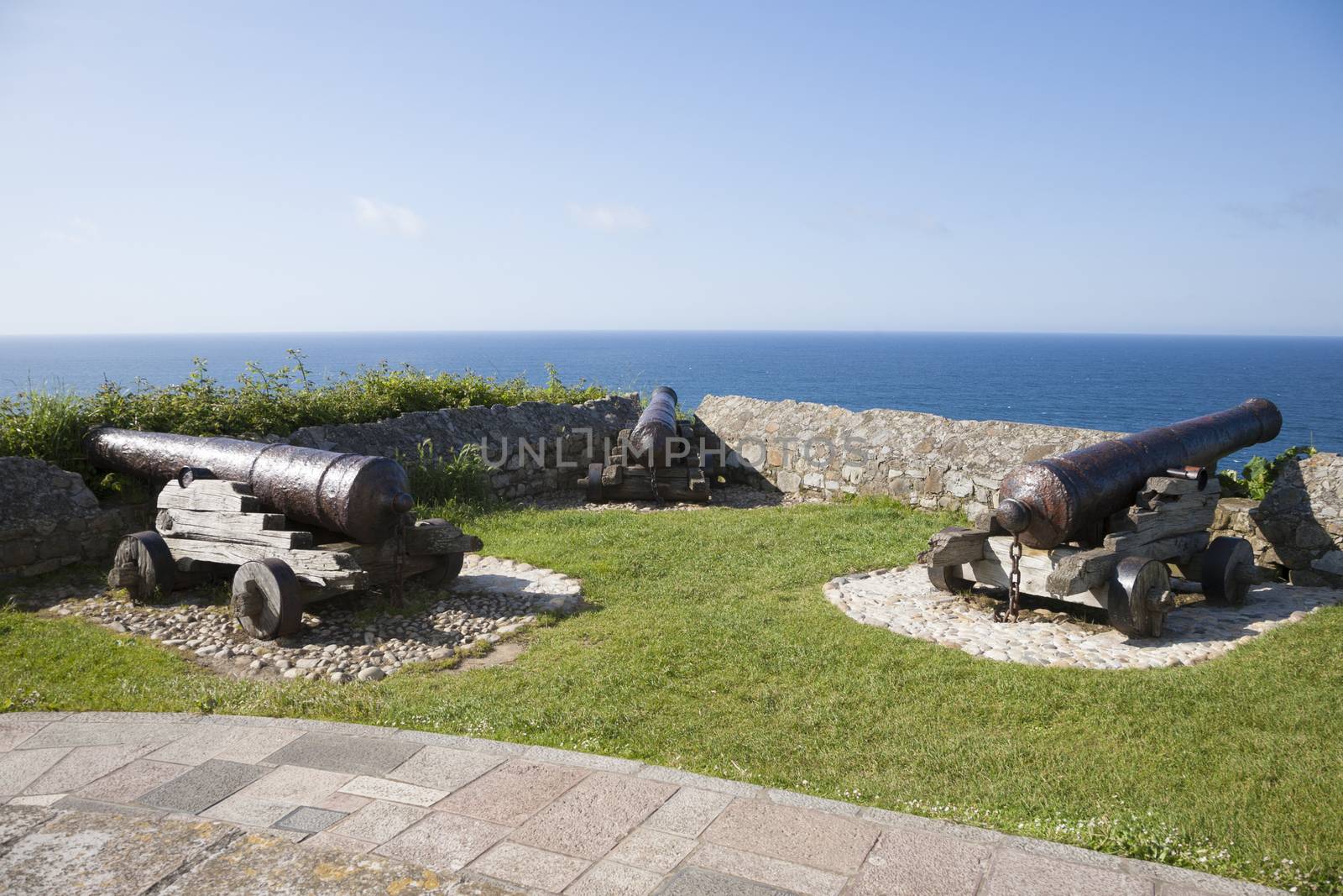 three ancient bronze cannons waterfront in Ribadesella city Asturias Spain Europe