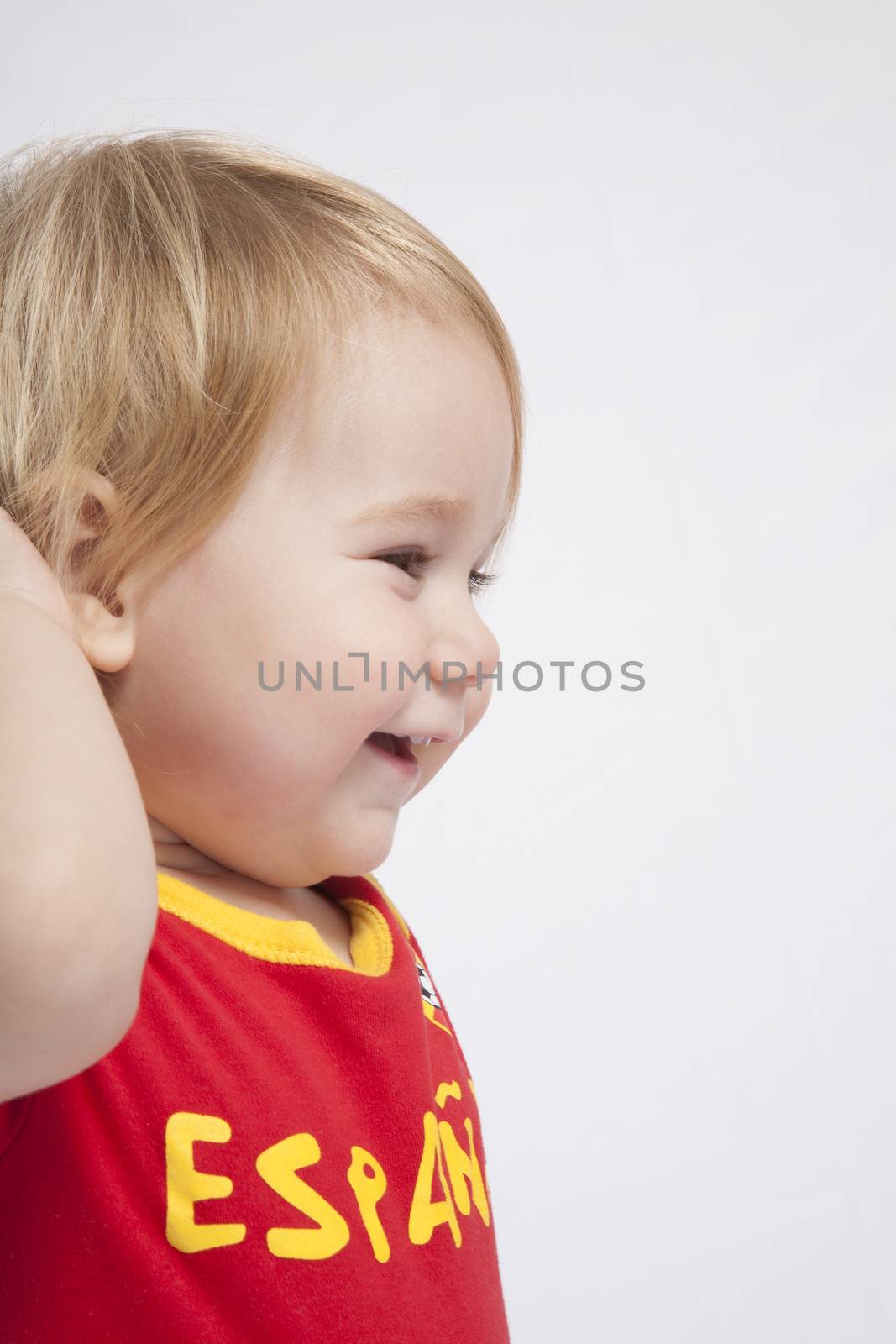 blonde baby sixteen month old with red shirt of Spanish soccer team