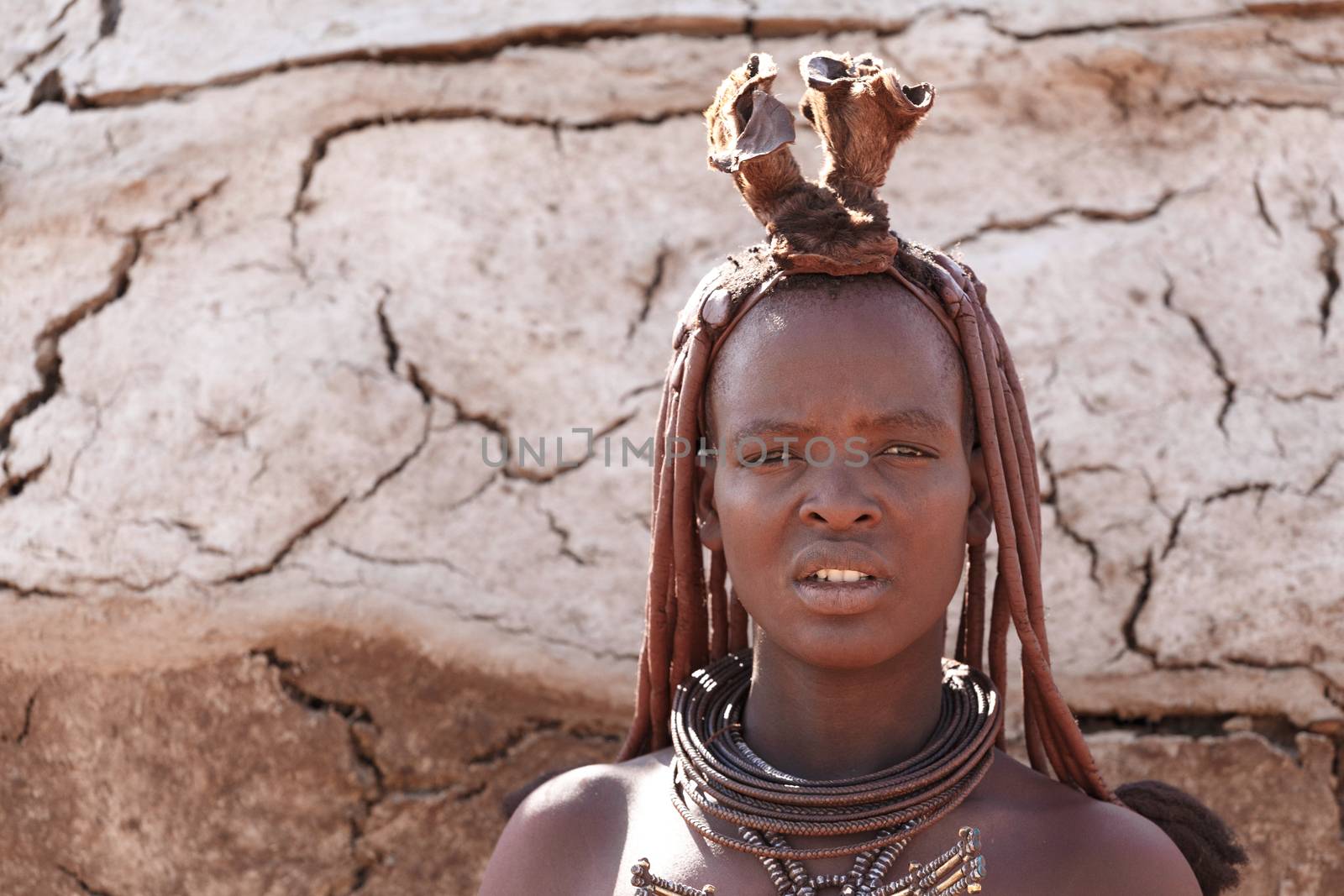 NAMIBIA, KAMANJAB, OCTOBER 10: Himba tribe woman with ornaments on the neck, in the village of Himba people near Kamanjab in northern Namibia, October 10, 2014, Namibia