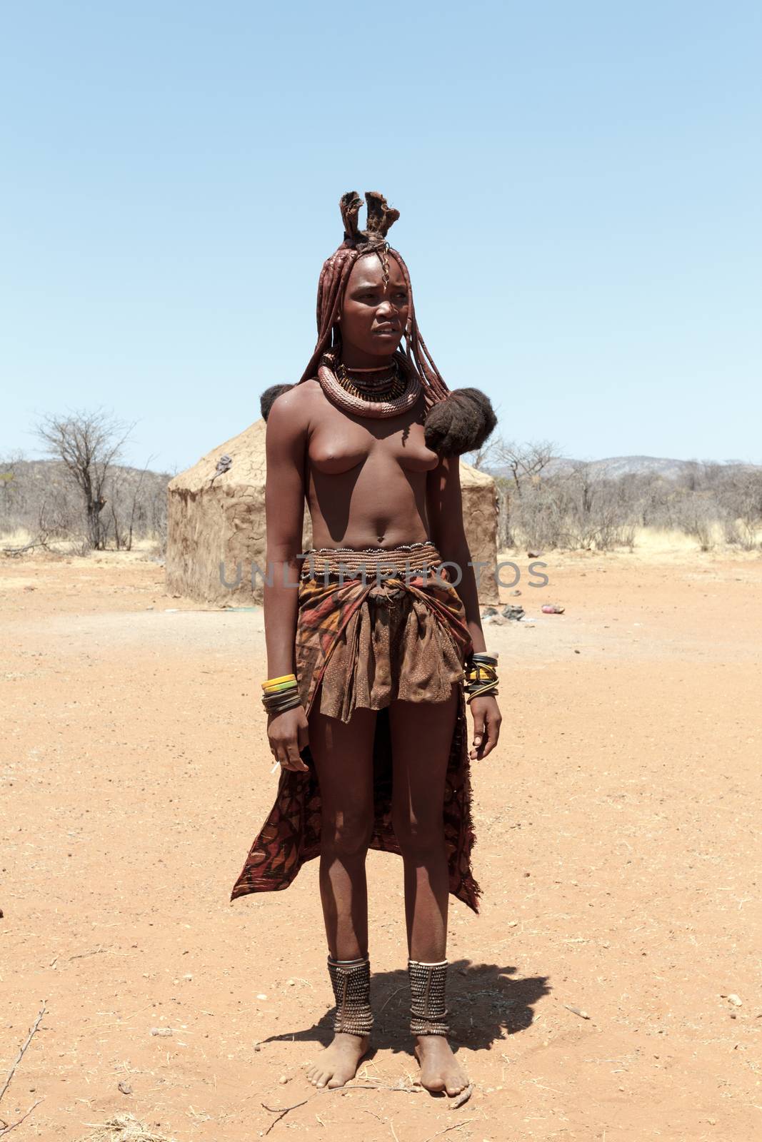NAMIBIA, KAMANJAB, OCTOBER 10: Himba tribe woman with ornaments on the neck, in the village of Himba people near Kamanjab in northern Namibia, October 10, 2014, Namibia