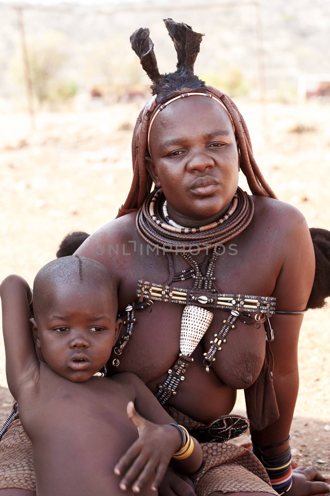 NAMIBIA, KAMANJAB, OCTOBER 10: Himba tribe woman with childs, in the village of Himba people near Kamanjab in northern Namibia, October 10, 2014, Namibia