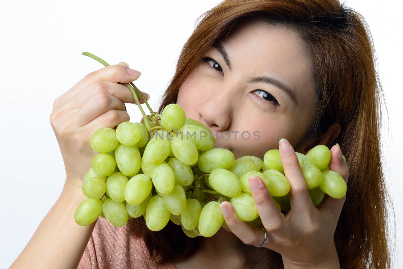 Beautiful asian woman with green grape