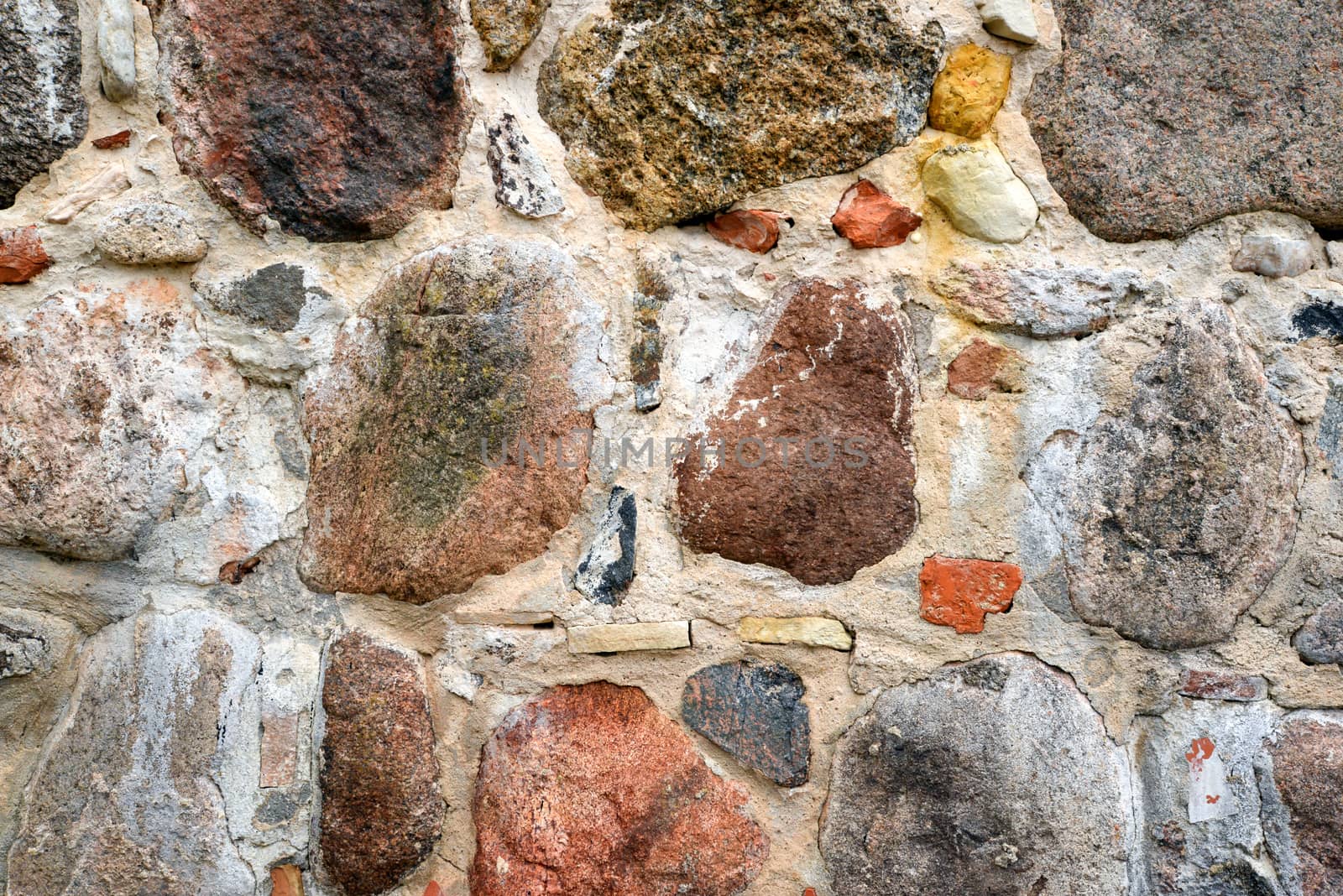 Photo of a colourful stone wall. May be used for texture and background.