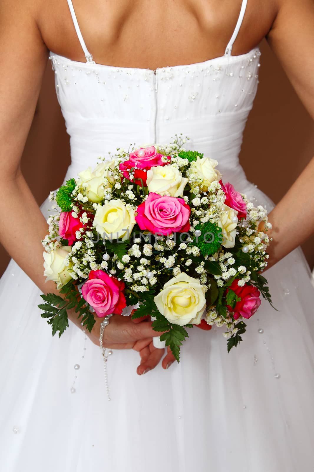 The bride holds a wedding bouquet