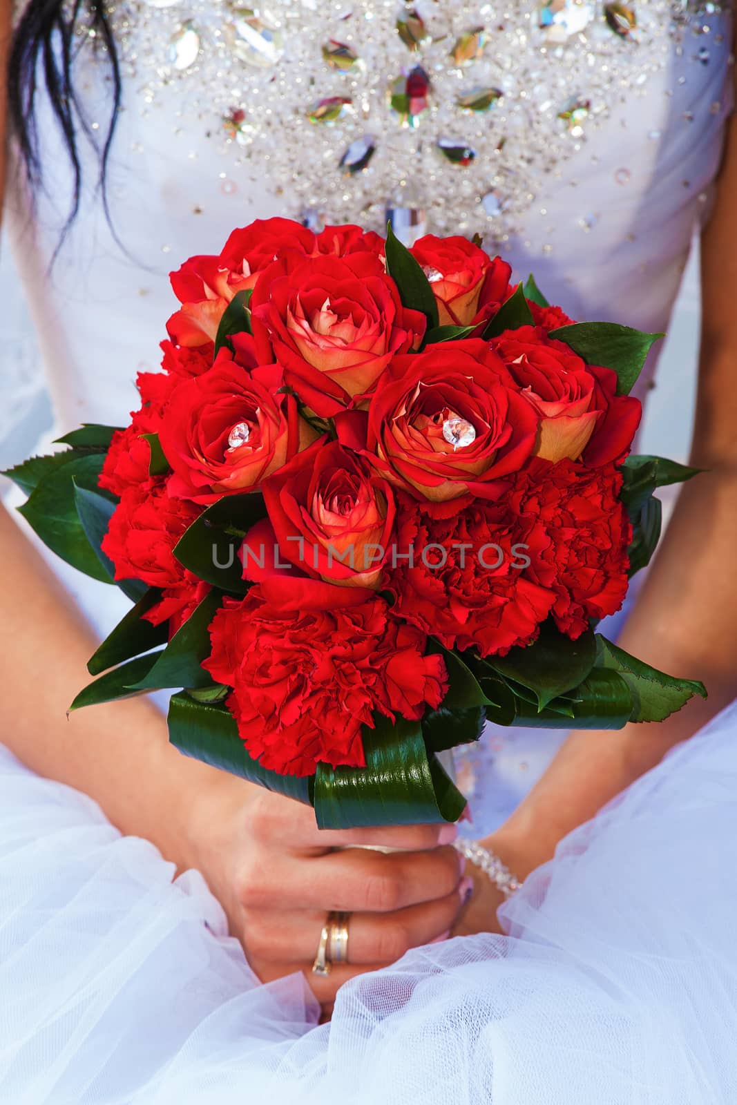 The bride holds a wedding bouquet