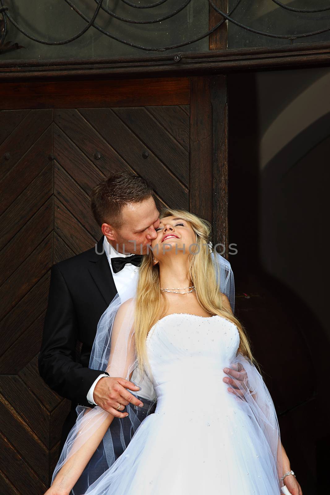 Groom kissing his beautiful wife