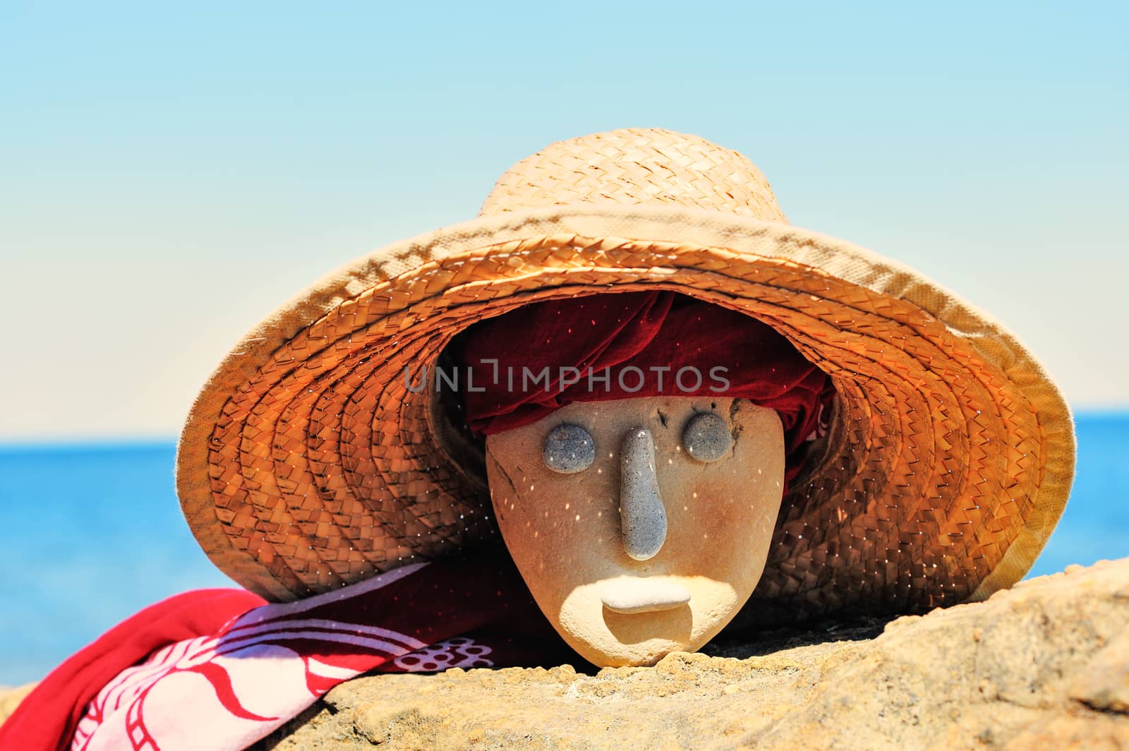 Stone head with a wicker hat and bandana