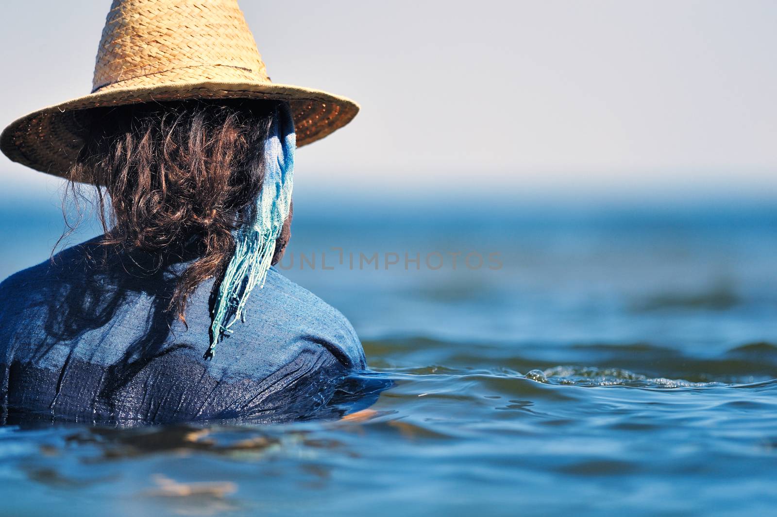 Swimming in seawater. Woman in wet dress