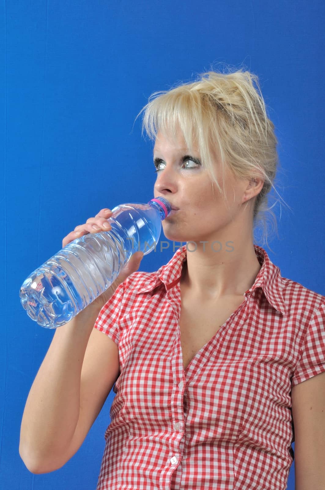 Blond woman drinking water