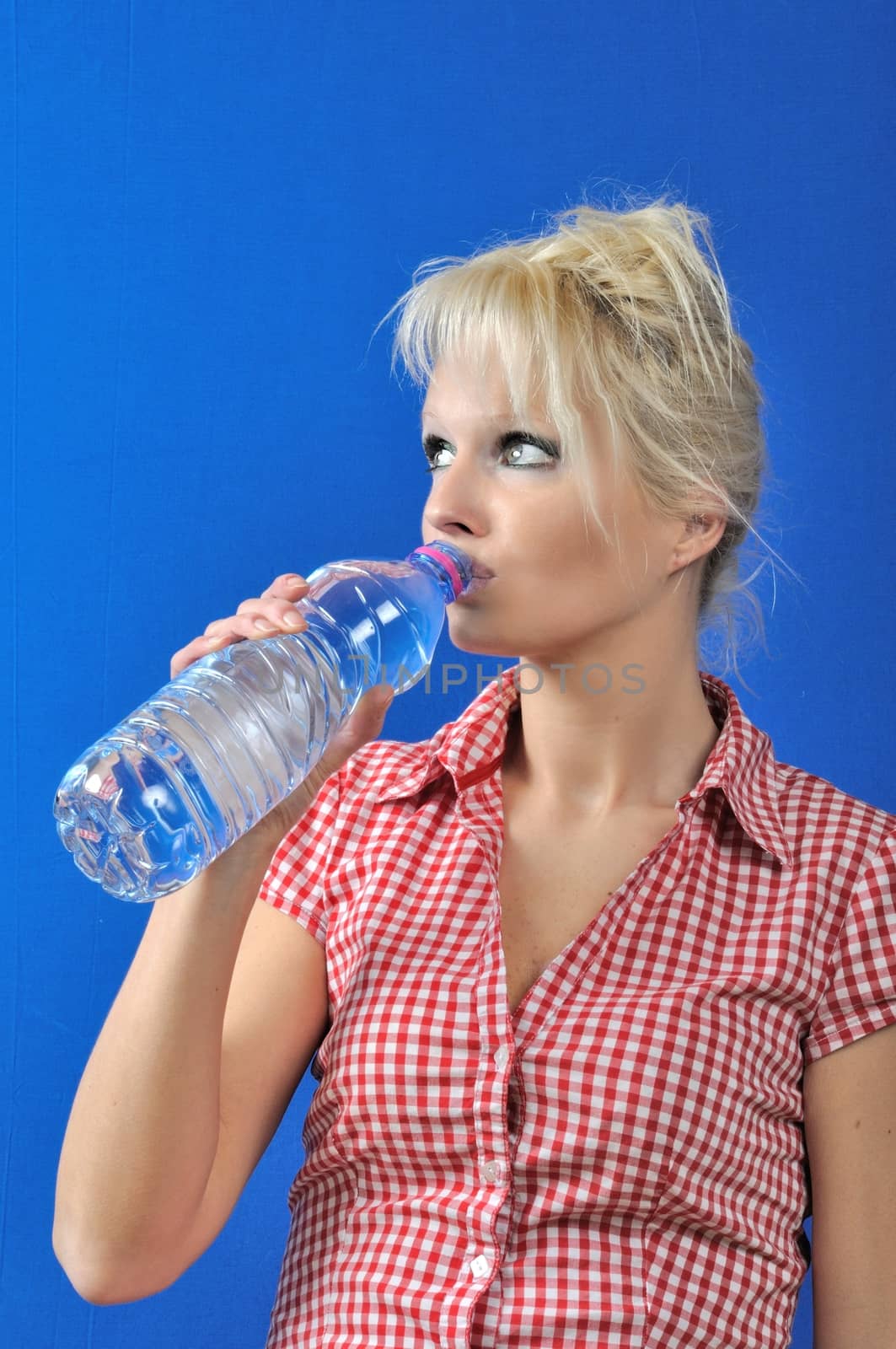 Blond woman drinking water