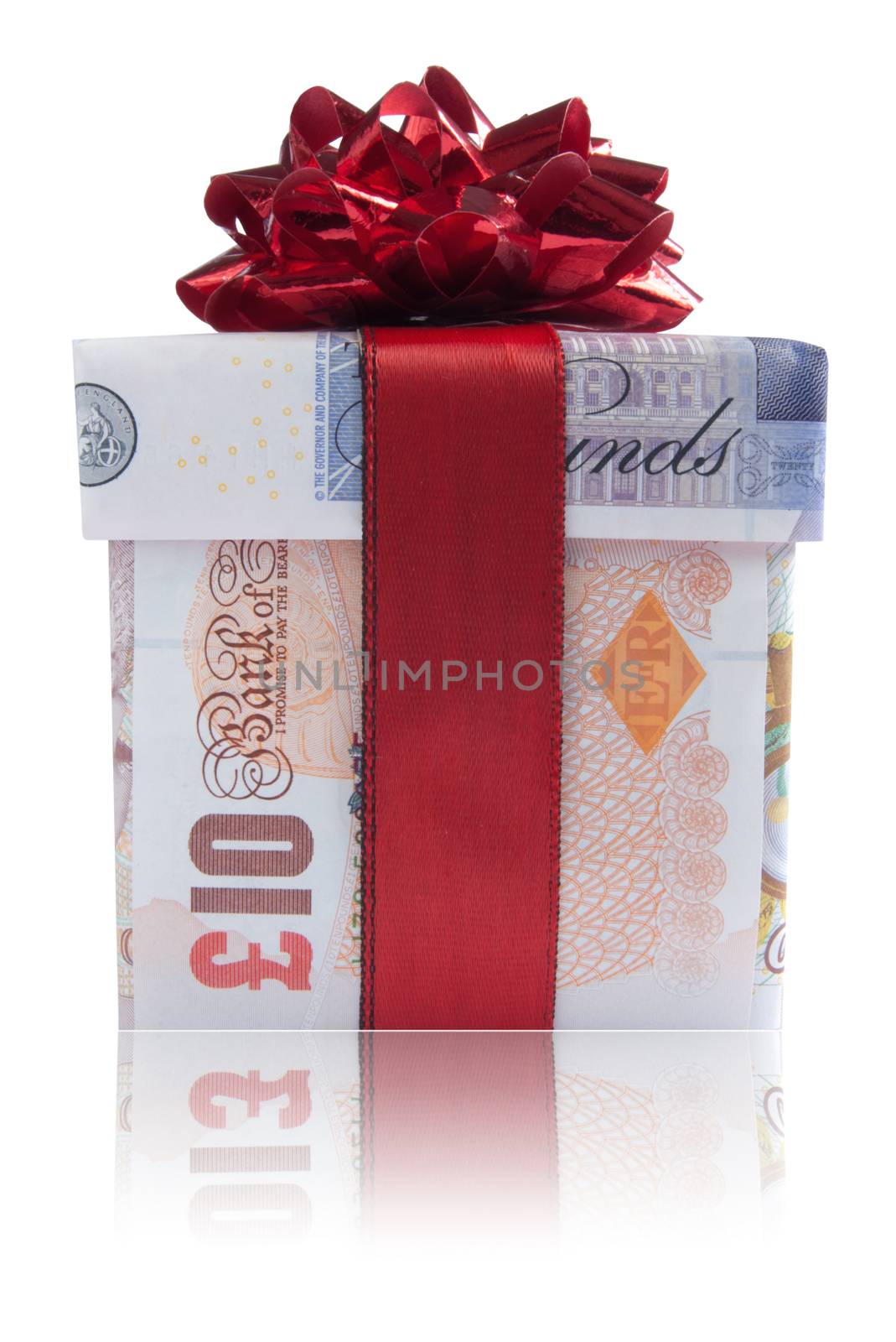 Gift box wrapped with sterling pound banknotes with  red silk ribbon
