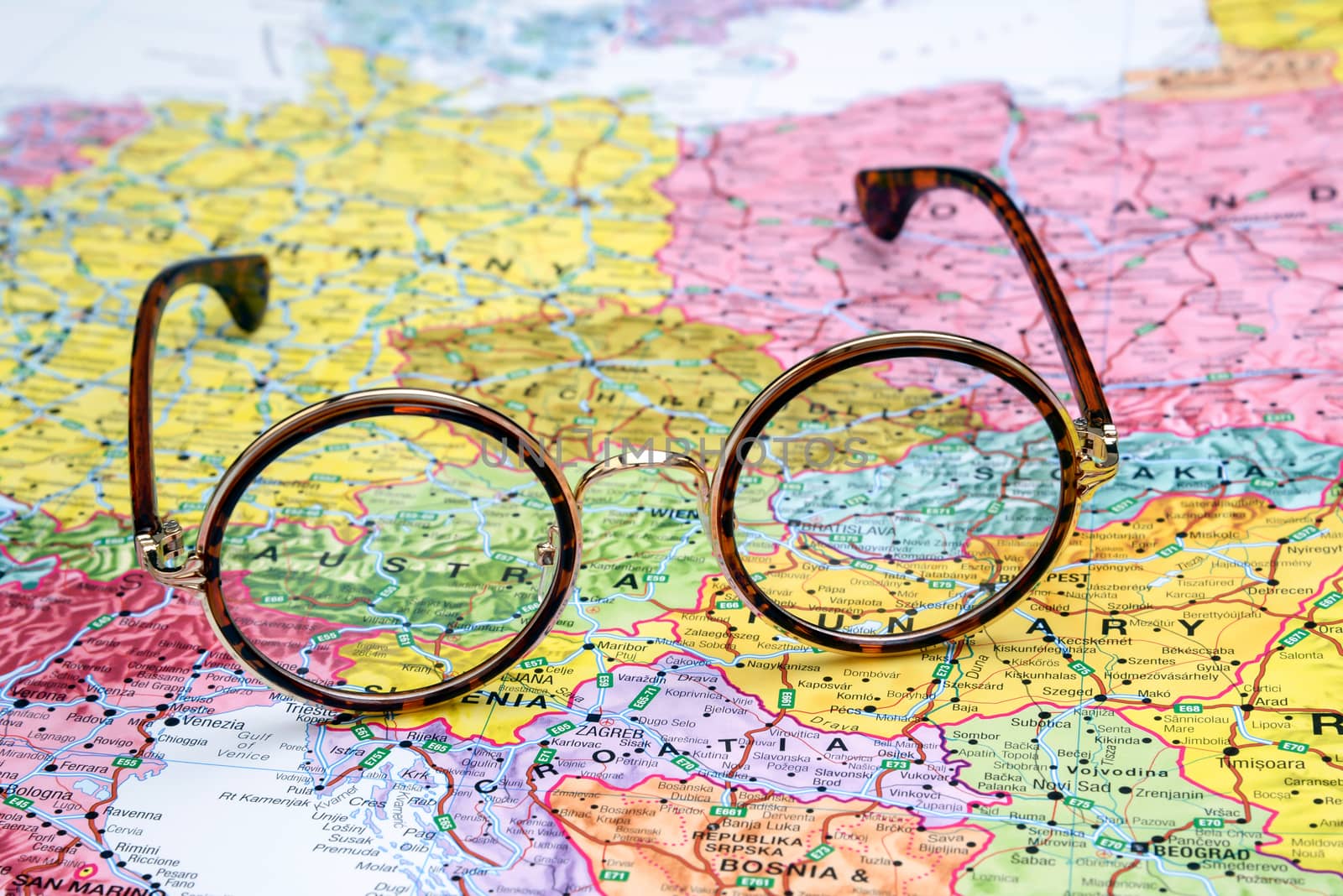 Photo of glasses on a map of europe. Focus on Austria. May be used as illustration for traveling theme.