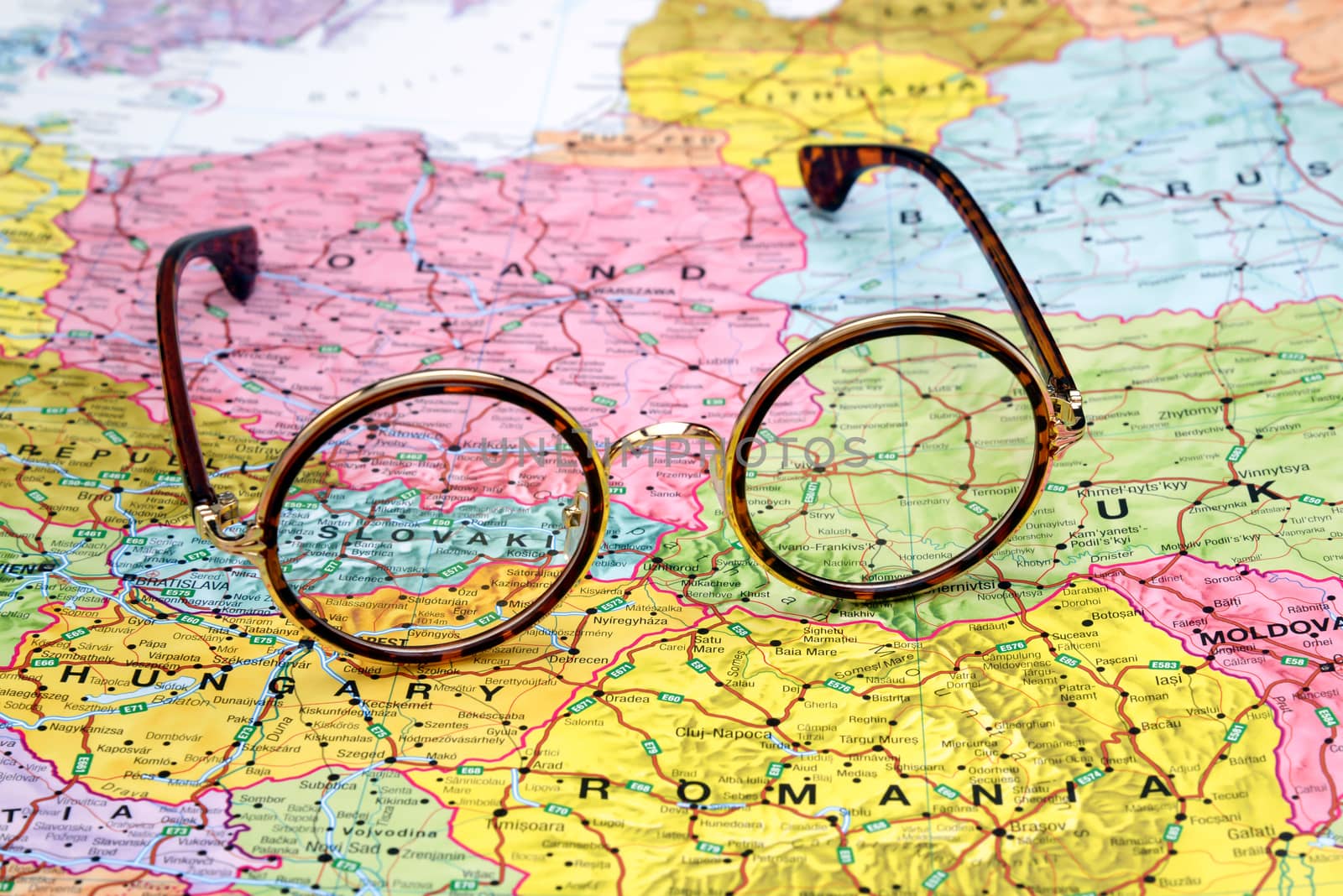 Photo of glasses on a map of europe. Focus on Slovakia. May be used as illustration for traveling theme.