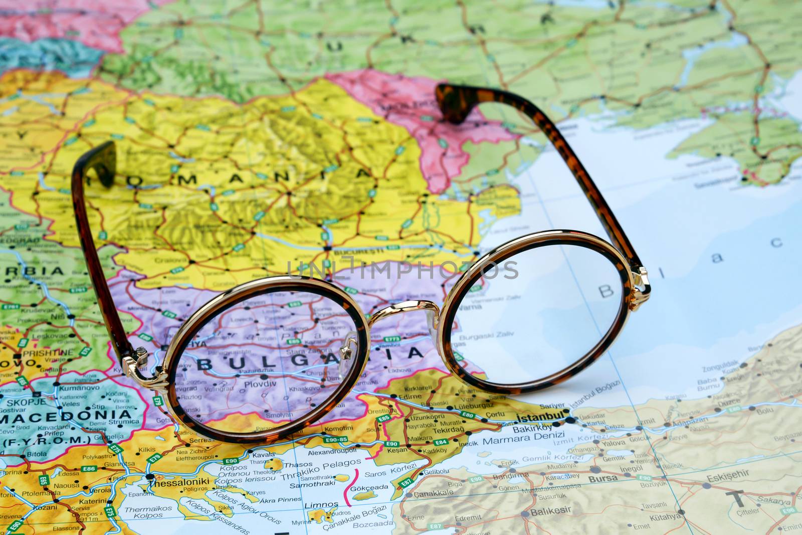 Photo of glasses on a map of europe. Focus on Bulgaria. May be used as illustration for traveling theme.