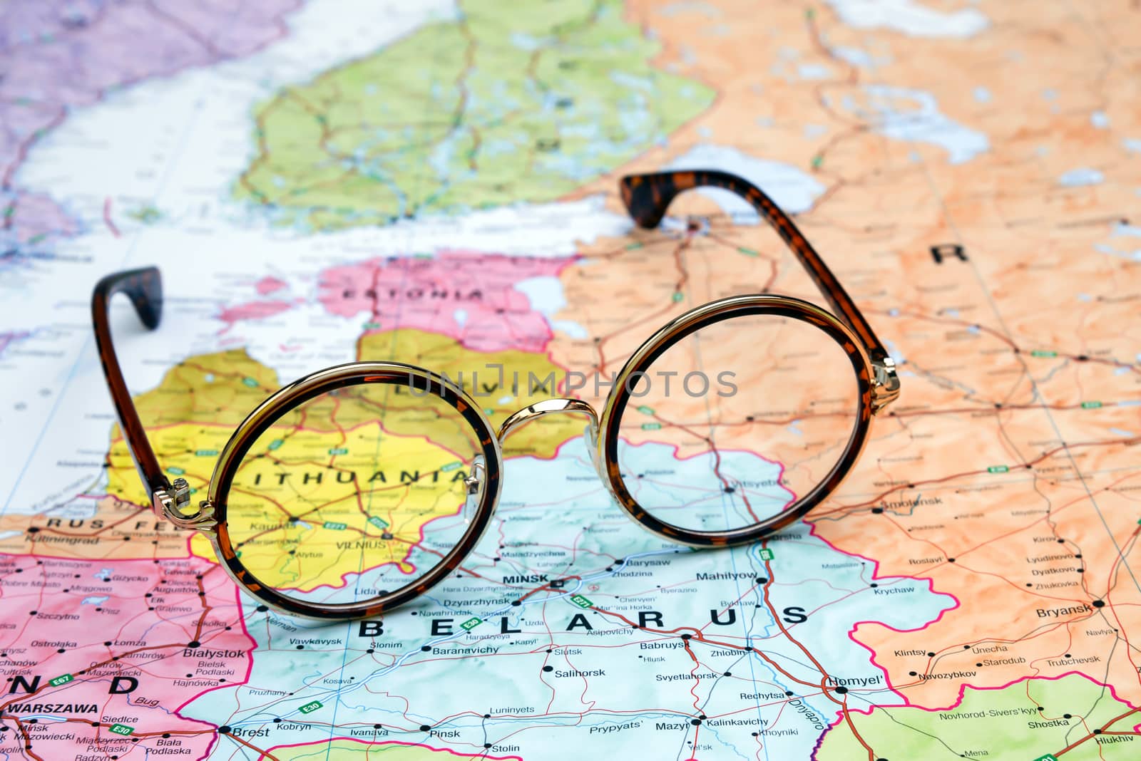 Photo of glasses on a map of europe. Focus on Lithuania. May be used as illustration for traveling theme.