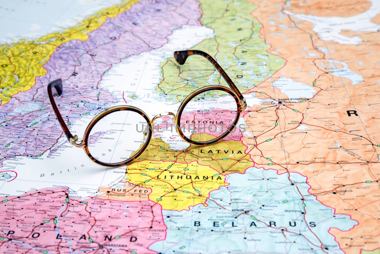 Photo of glasses  on a map of europe. Focus on Estonia. May be used as illustration for traveling theme.