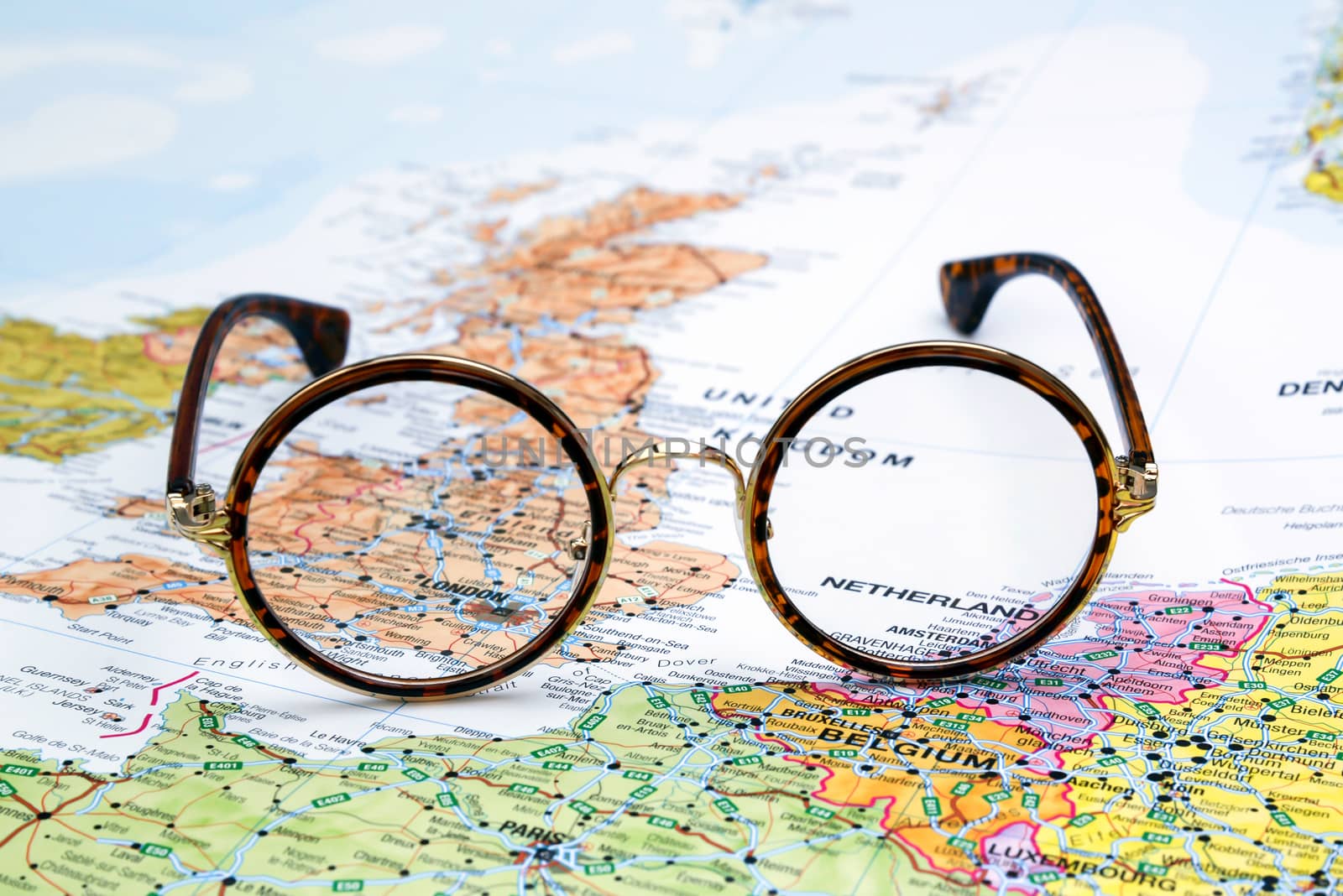 Photo of glasses on a map of europe. Focus on London, Great Britain. May be used as illustration for traveling theme.