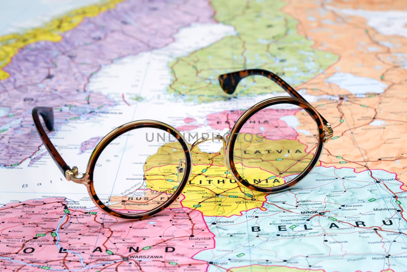Photo of glasses on a map of europe. Focus on Latvia. May be used as illustration for traveling theme.