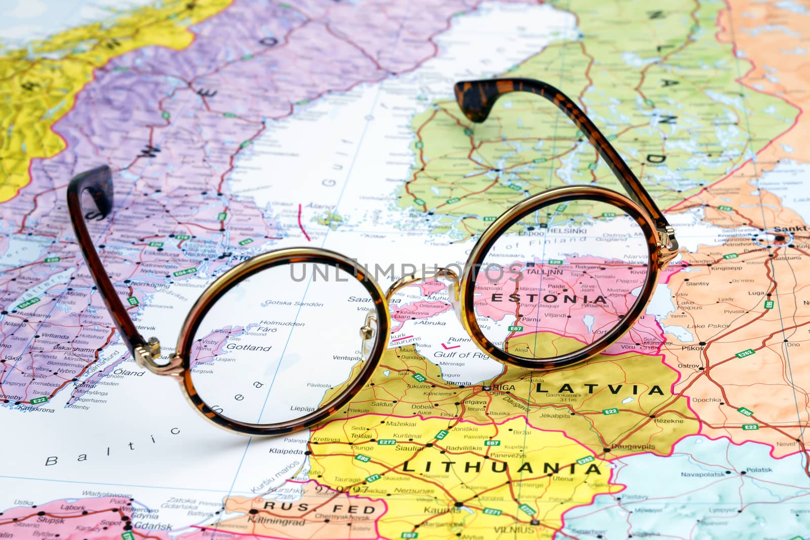 Photo of glasses  on a map of europe. Focus on Estonia. May be used as illustration for traveling theme.