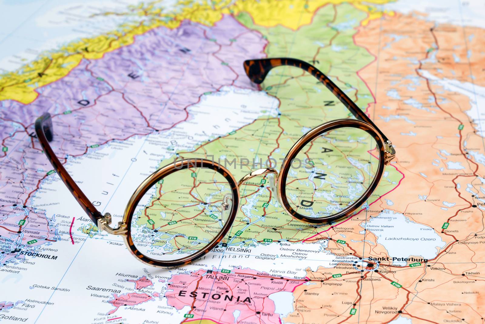 Photo of glasses on a map of europe. Focus on Finland. May be used as illustration for traveling theme.