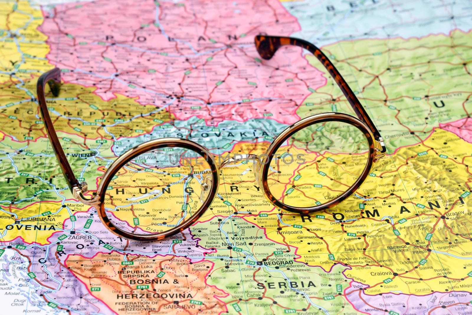 Photo of glasses on a map of europe. Focus on Hungary. May be used as illustration for traveling theme.