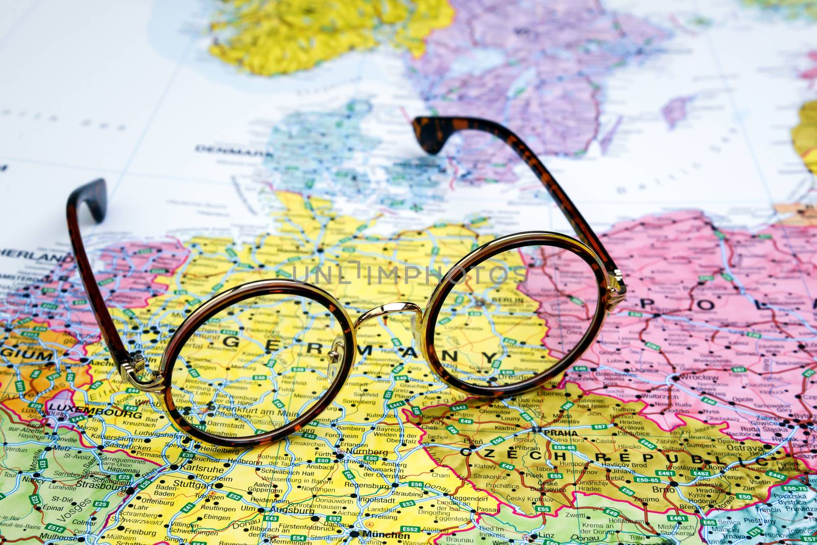 Photo of glasses on a map of europe. Focus on Germany. May be used as illustration for traveling theme.
