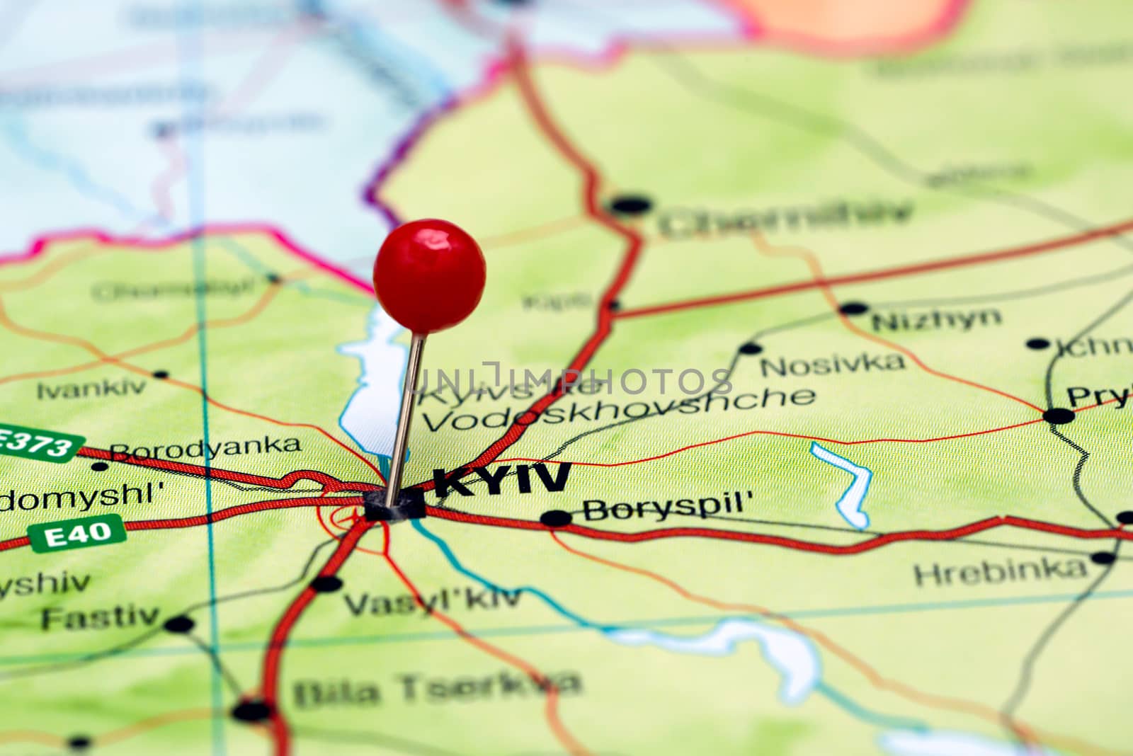 Photo of pinned Kyiv on a map of europe. May be used as illustration for traveling theme.