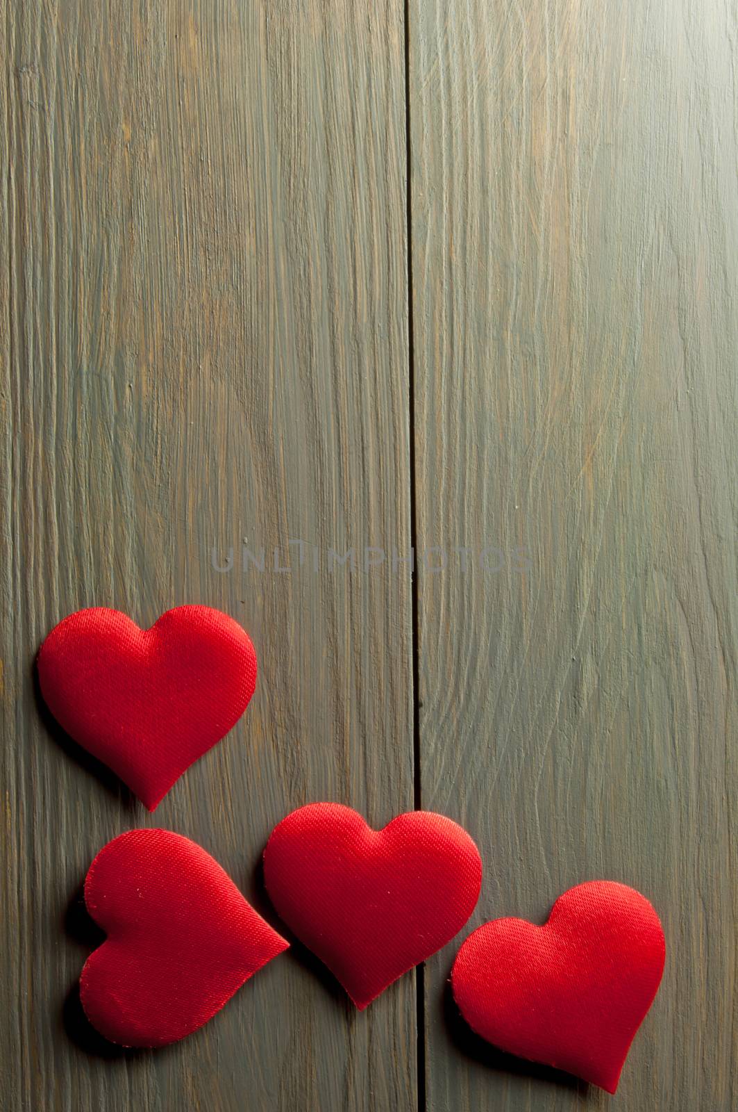 Love hearts border over a wood background with space 