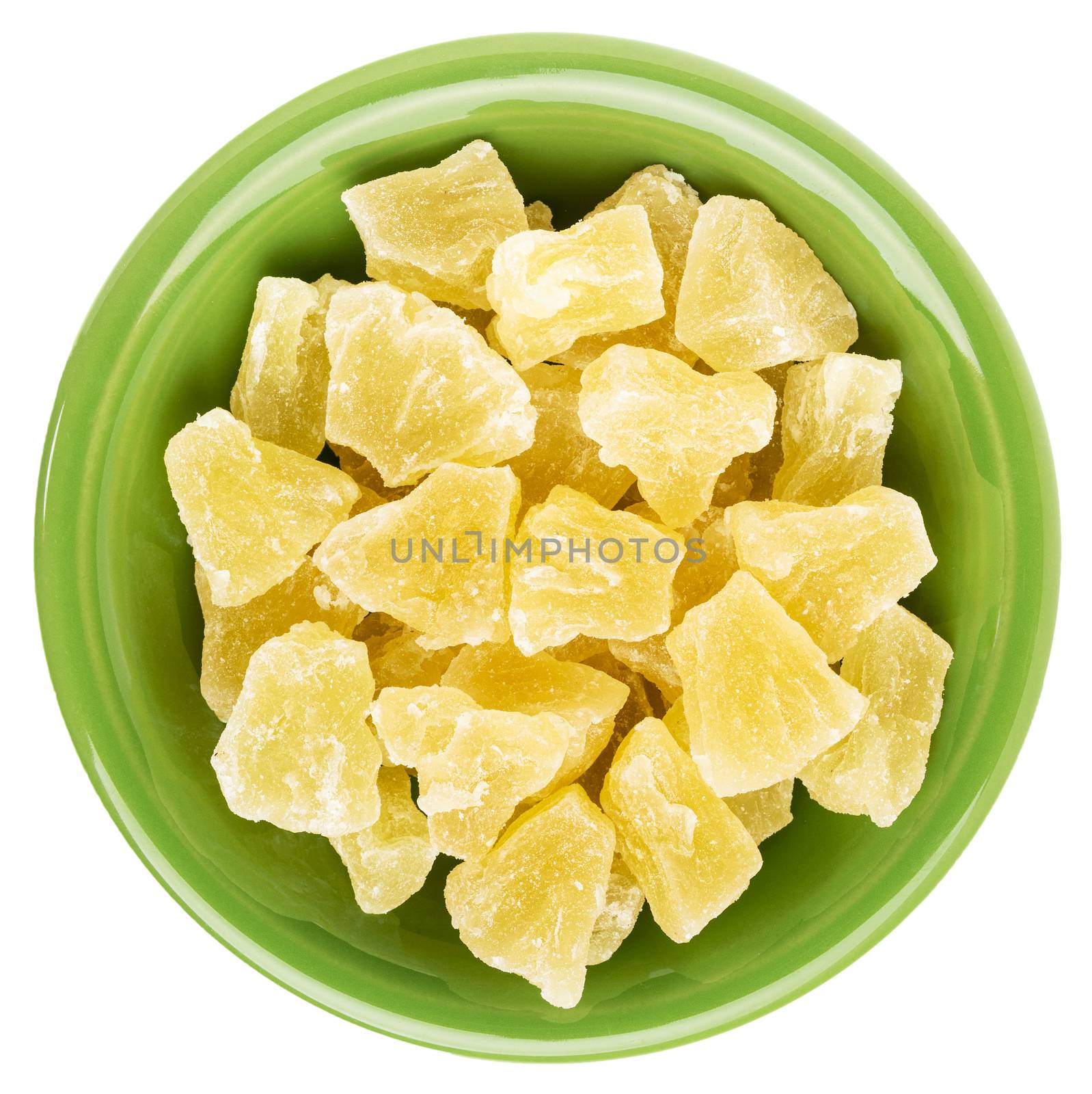 chunks of dried pineapple in an isolated green ceramic bowl