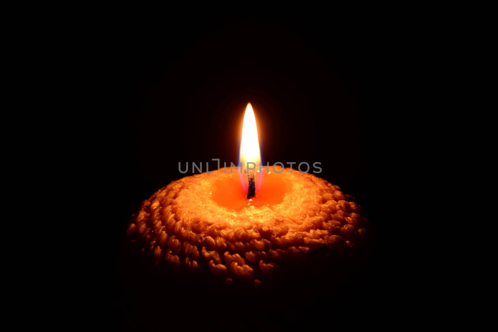 Yellow candle burning on a black background by dk_photos