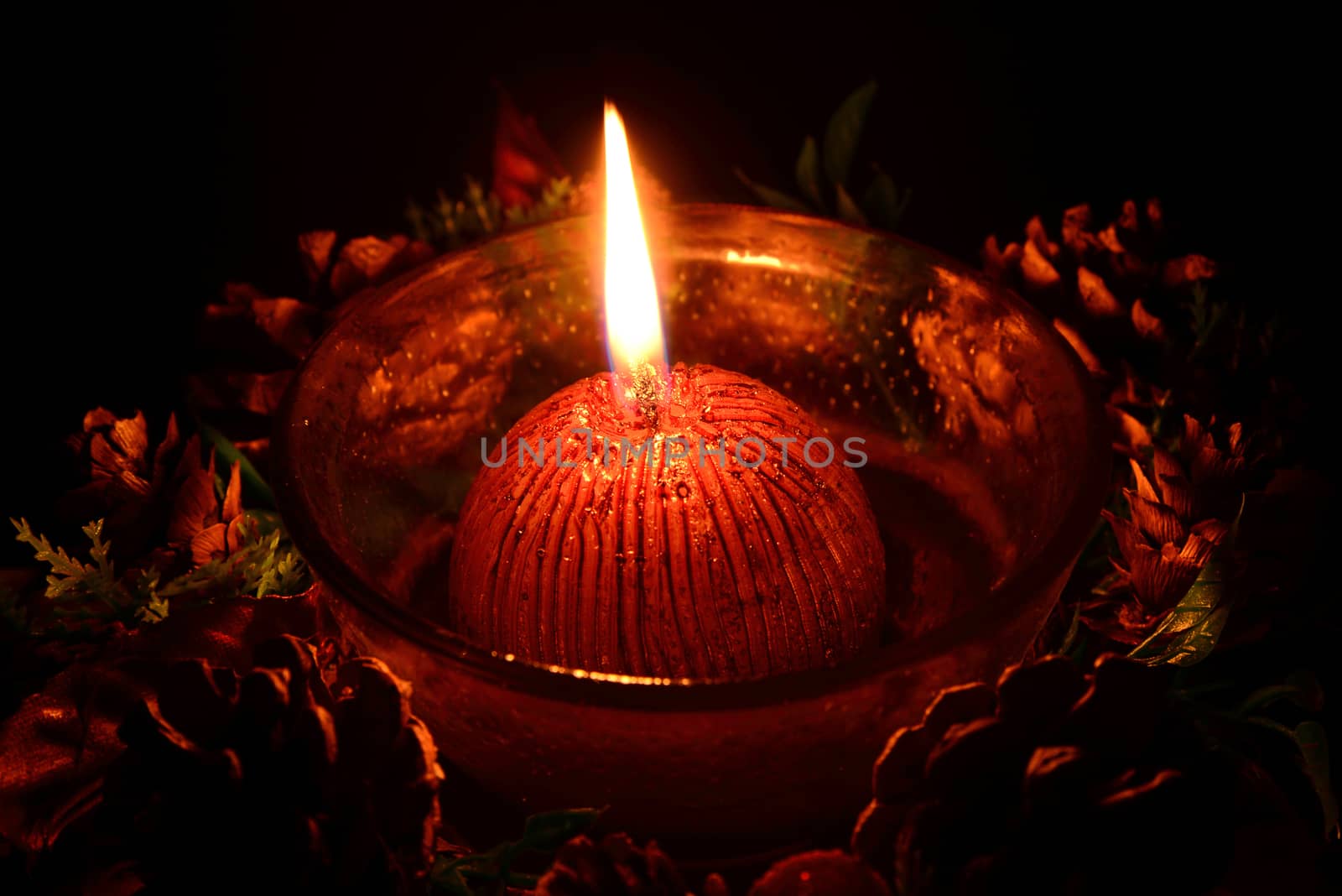 Red christmas candle burning on a black background by dk_photos