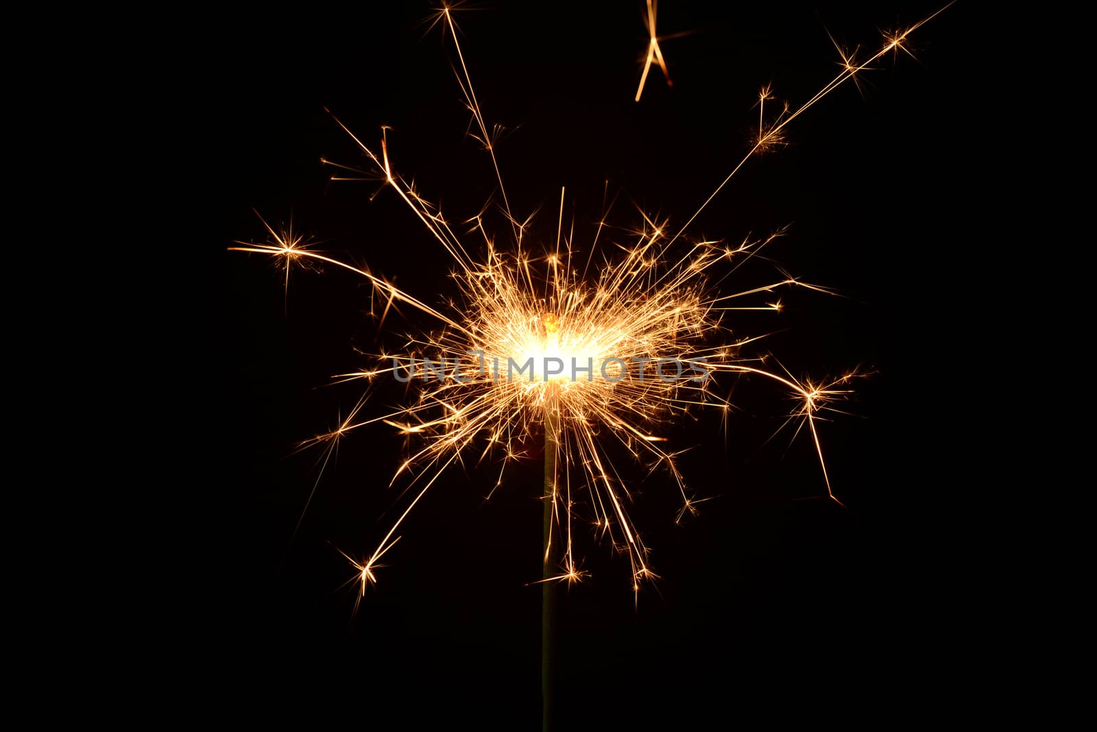 Photo of a burning christmas sparkler on a black background