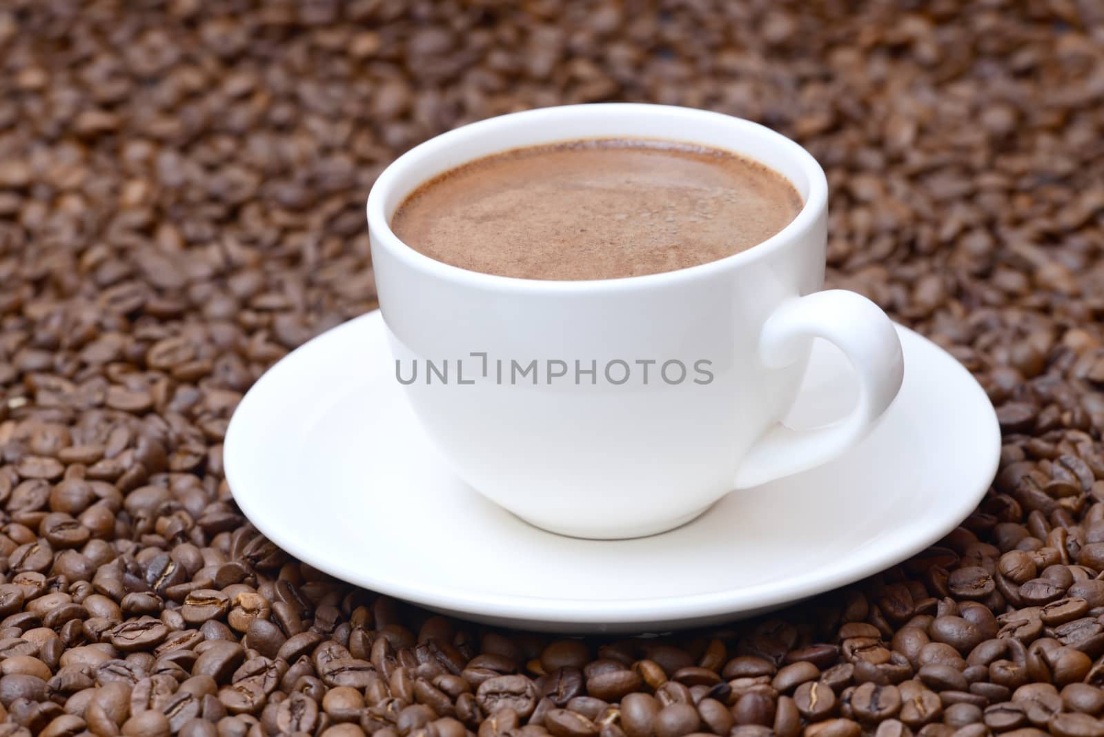 cup of coffee on a coffee beans background by dk_photos