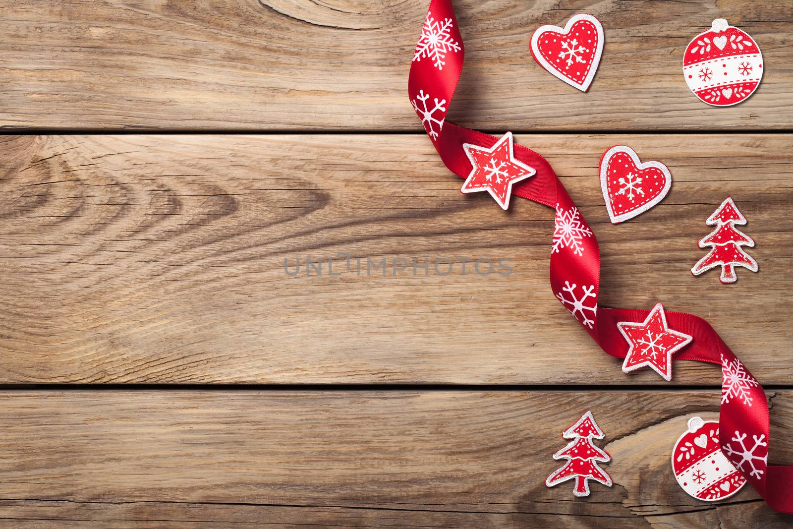 Christmas background with red decoration on wooden table. Copy space. Top view