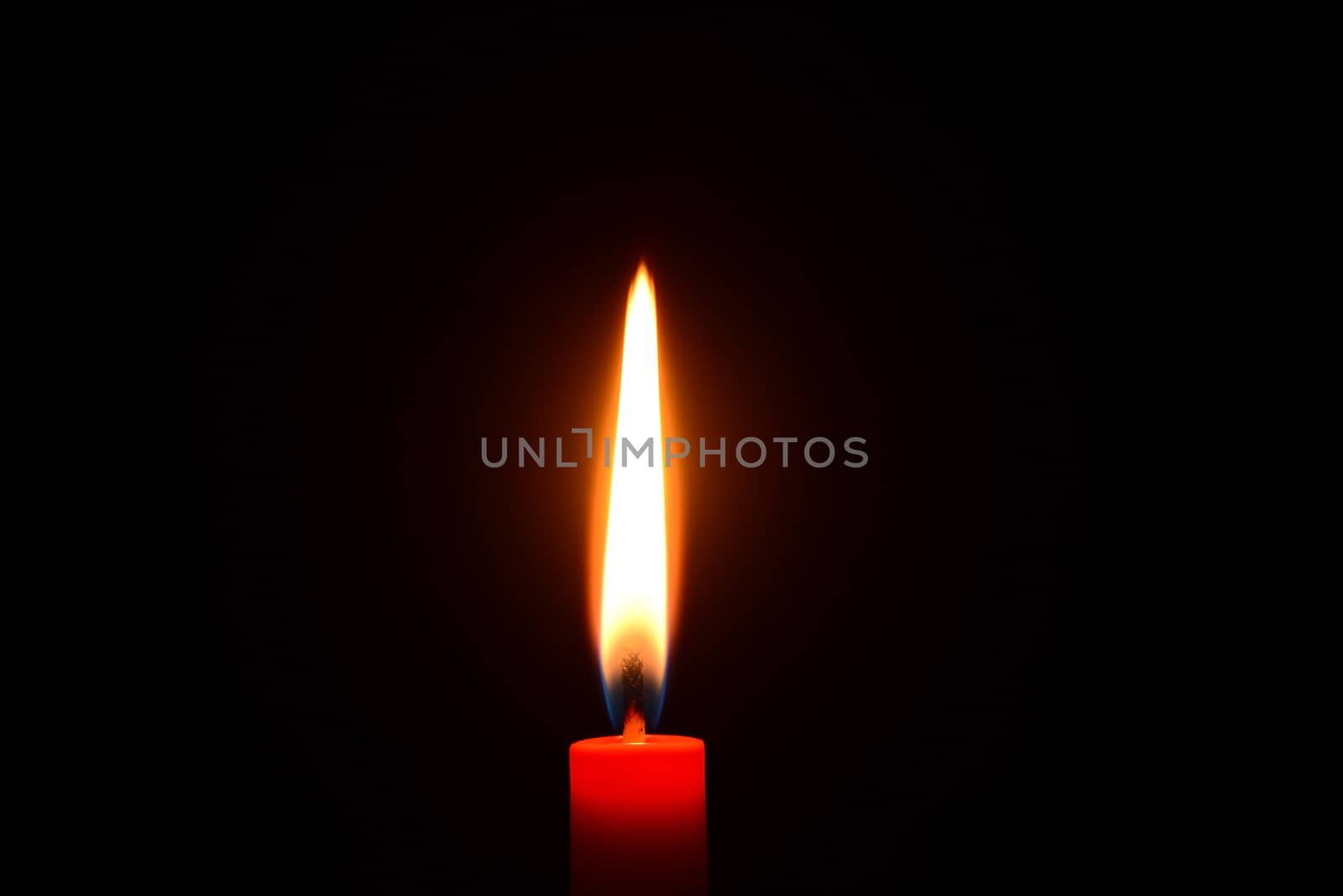 Red candle burning on a black background by dk_photos