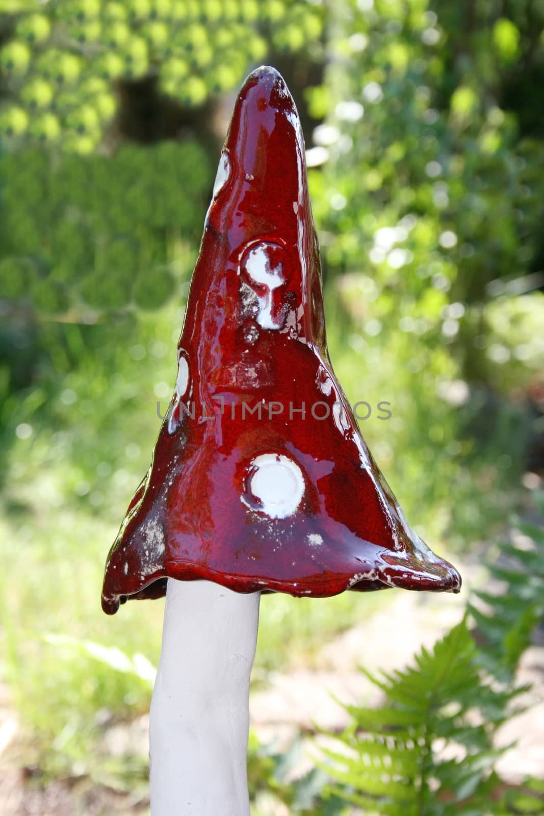 Handmade mushroom with white stem and red cap with white dots 