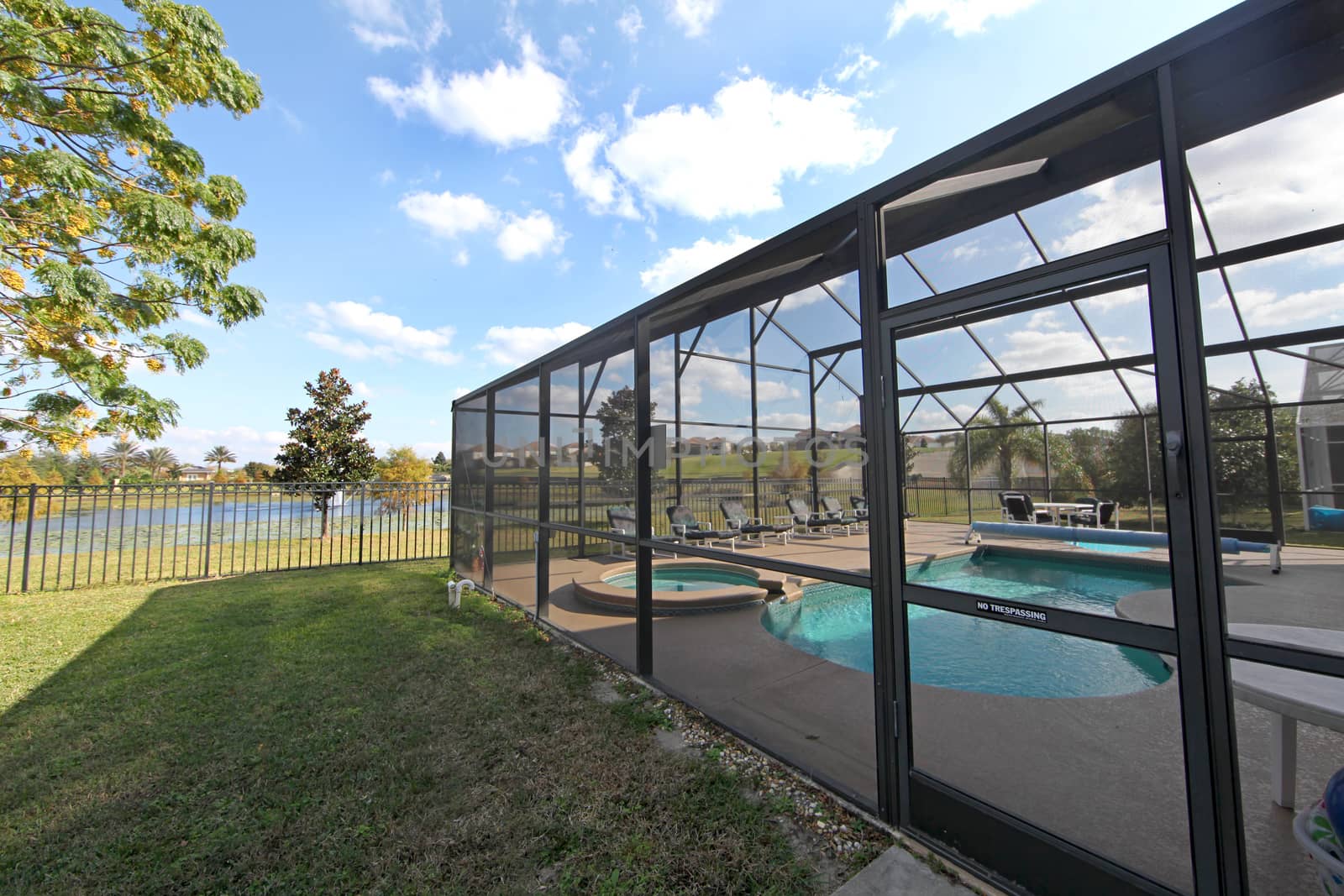 A Swimming Pool and Spa with Screen and Lake View