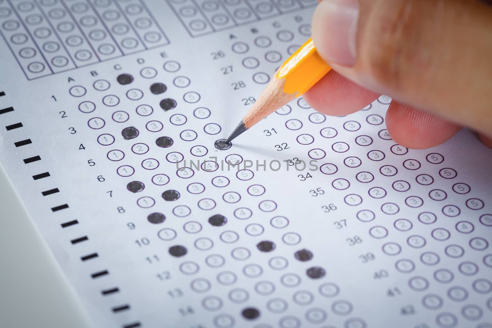 hand fill in Exam carbon paper computer sheet and pencil