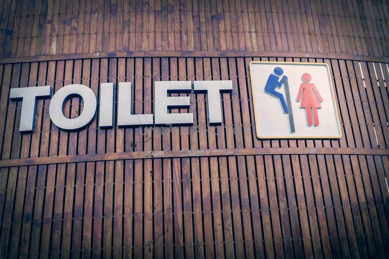 Man and a lady toilet sign on wood background by FrameAngel