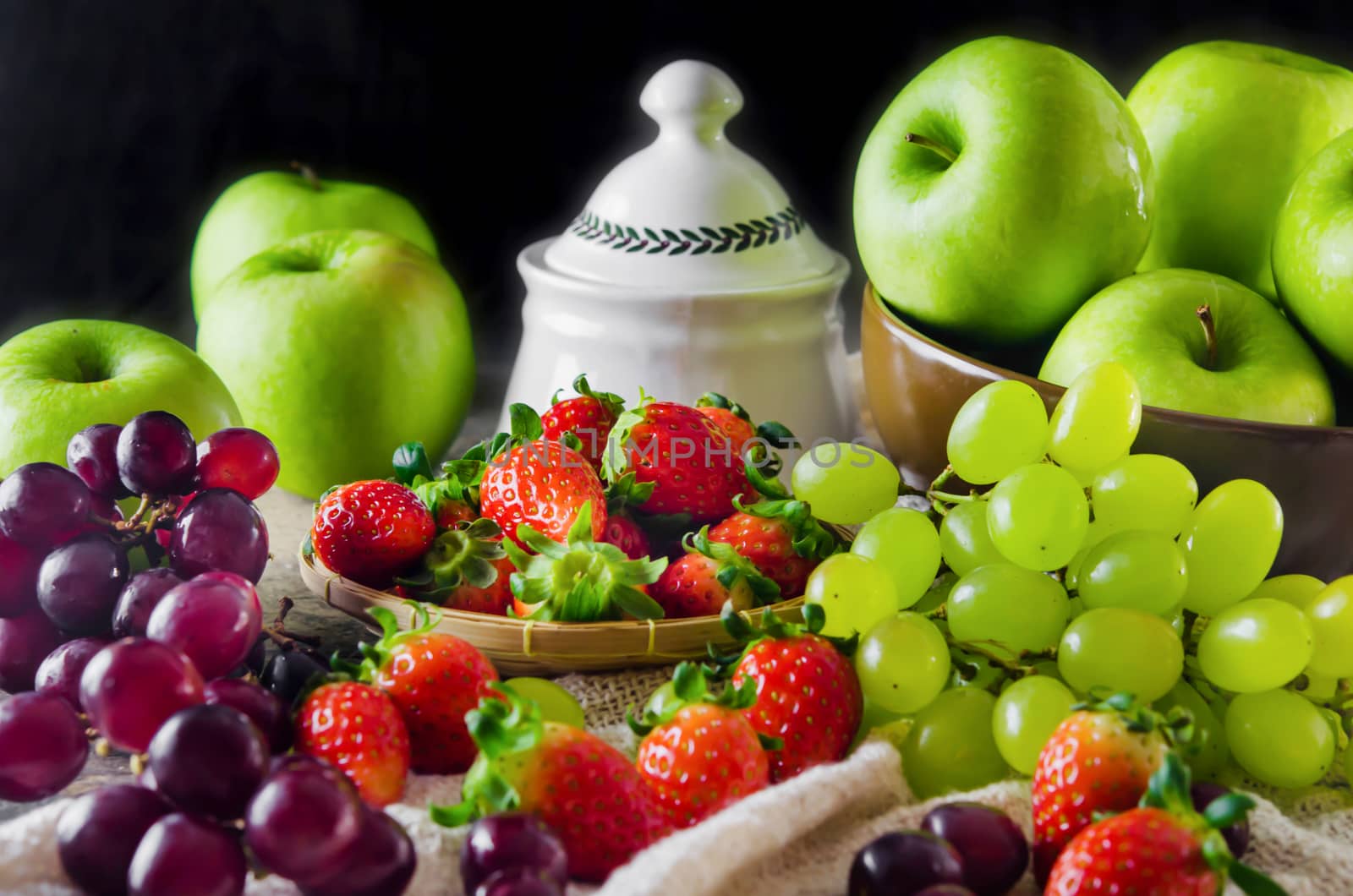 still life of mix fruits , apple with strawberry, pineapple and banana