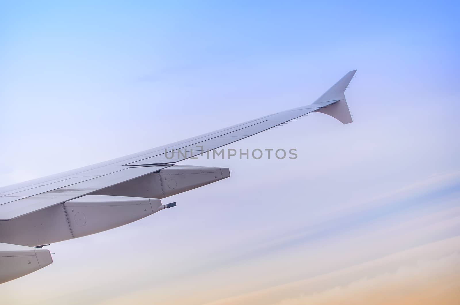 Wing seen through window of an aircraft