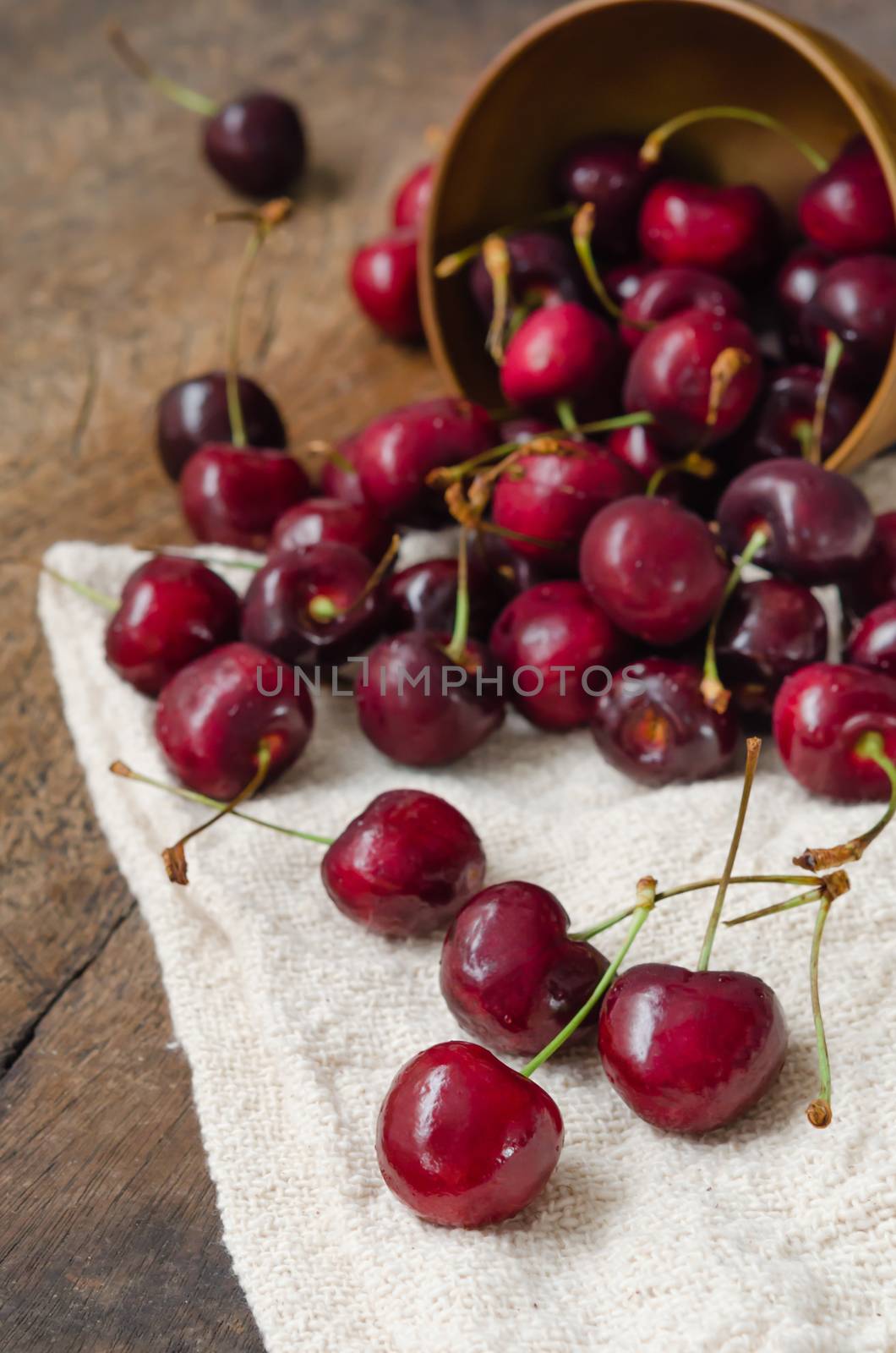 fresh cherries on wooden table  background