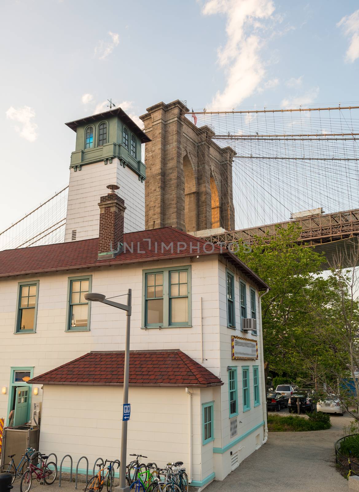 Brooklyn Bridge as seen from Brooklyn streets at sunset time.