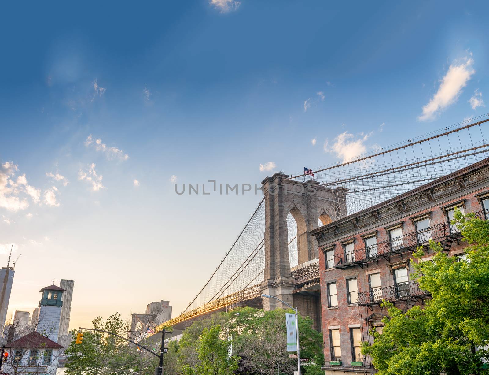 Brooklyn Bridge as seen from Brooklyn streets at sunset time by jovannig
