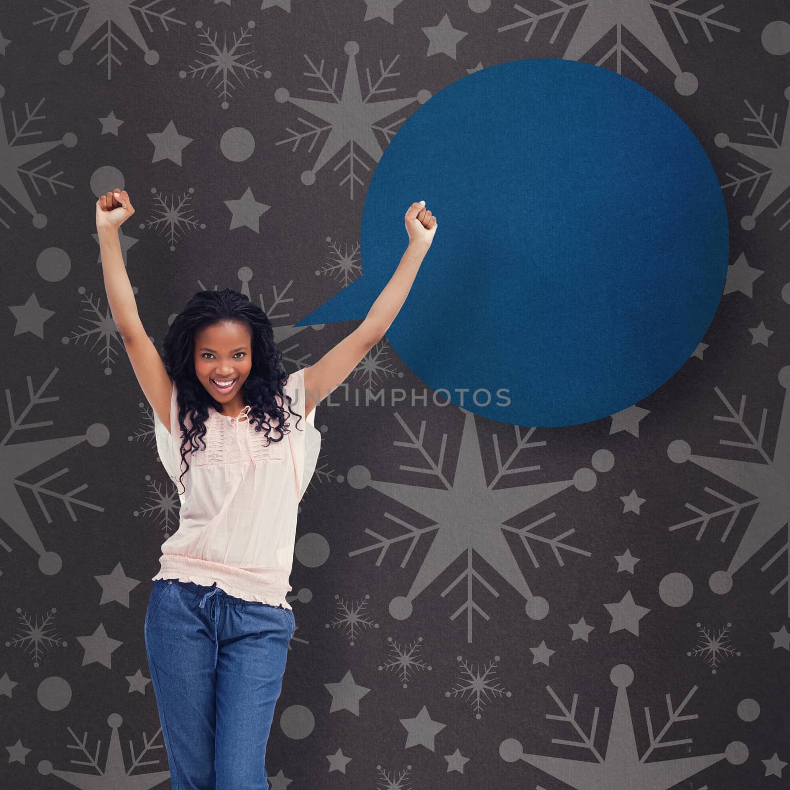 A young happy woman stands with her hands in the air against grey vignette