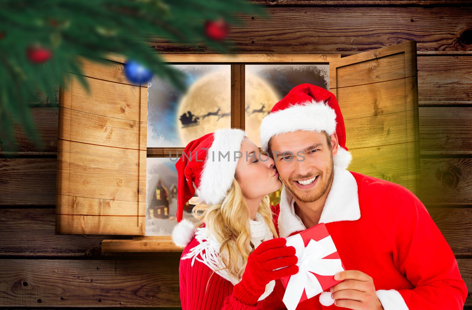 Young festive couple against santa delivery presents to village